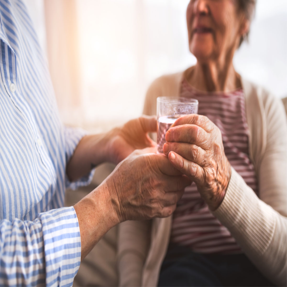 Two seniors drinking water