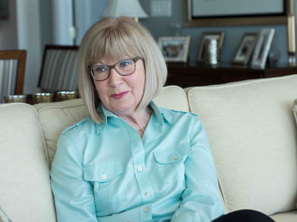 Mary B. sitting on a couch 